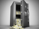 a open safe with stacks of money pouring out